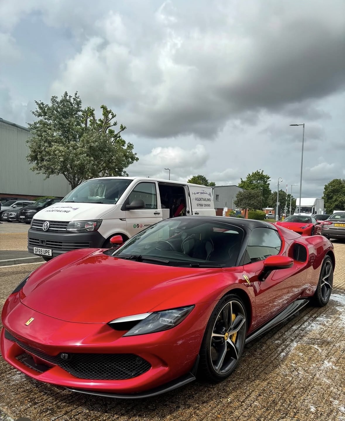 Red Ferrari 296 GTS beside HS Detailing van